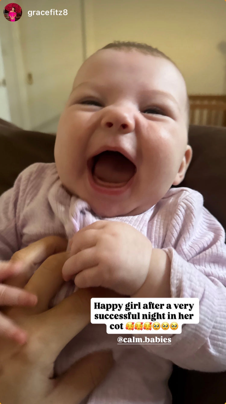 Baby laughing with a text overlay on a blurred background