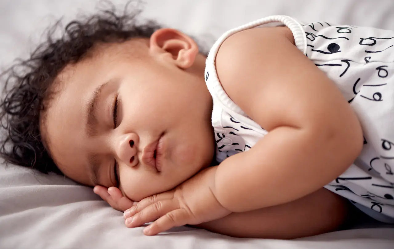 Baby sleeping peacefully on a soft surface