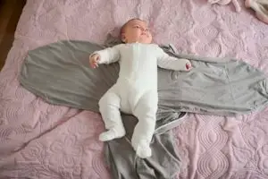 newborn baby getting ready to be swaddled in the Calm Babies- Calm Swaddle
